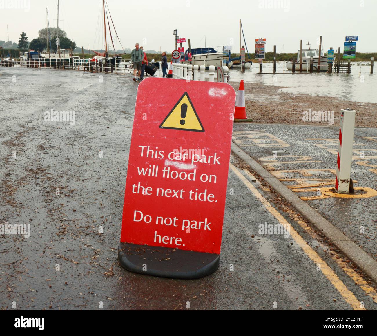 A warning sign not to park by the harbour channel due to due to high ...
