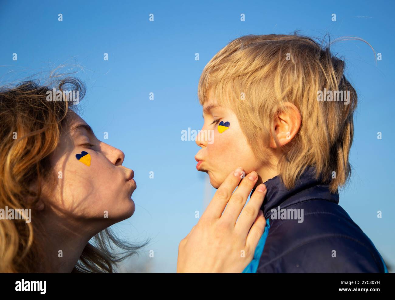 faces of two people - teenage girl and boy. sister and brother blow each other kiss Stock Photo
