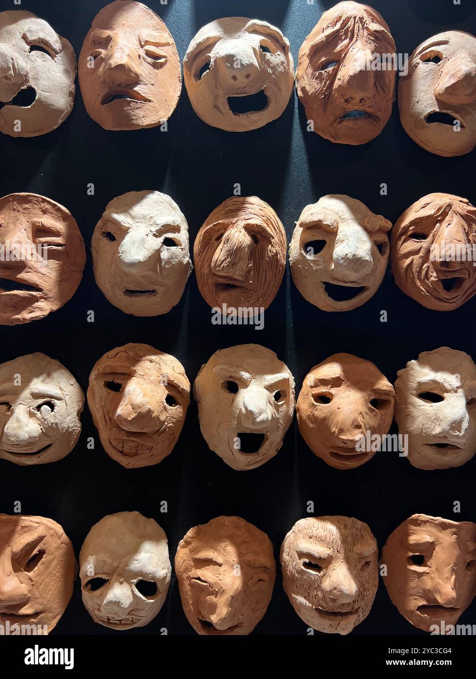 Clay masks in different emotion facial expressions, a visual artwork. - Smartphone Captured Stock Image