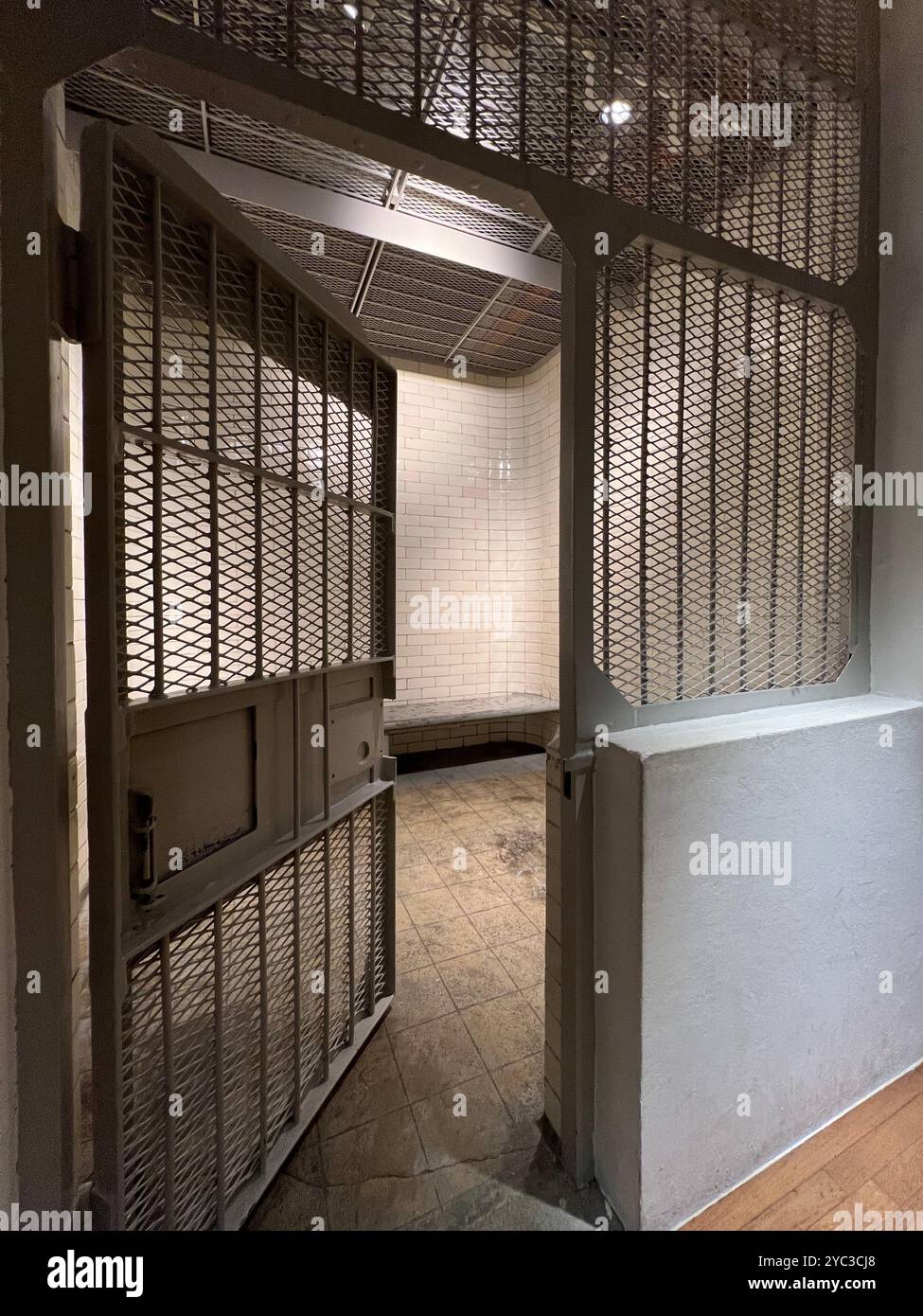 Prison cell interior open for public such as tourists visiting to experience the small room space inside. National Gallery Singapore. - Smartphone Captured Stock Image