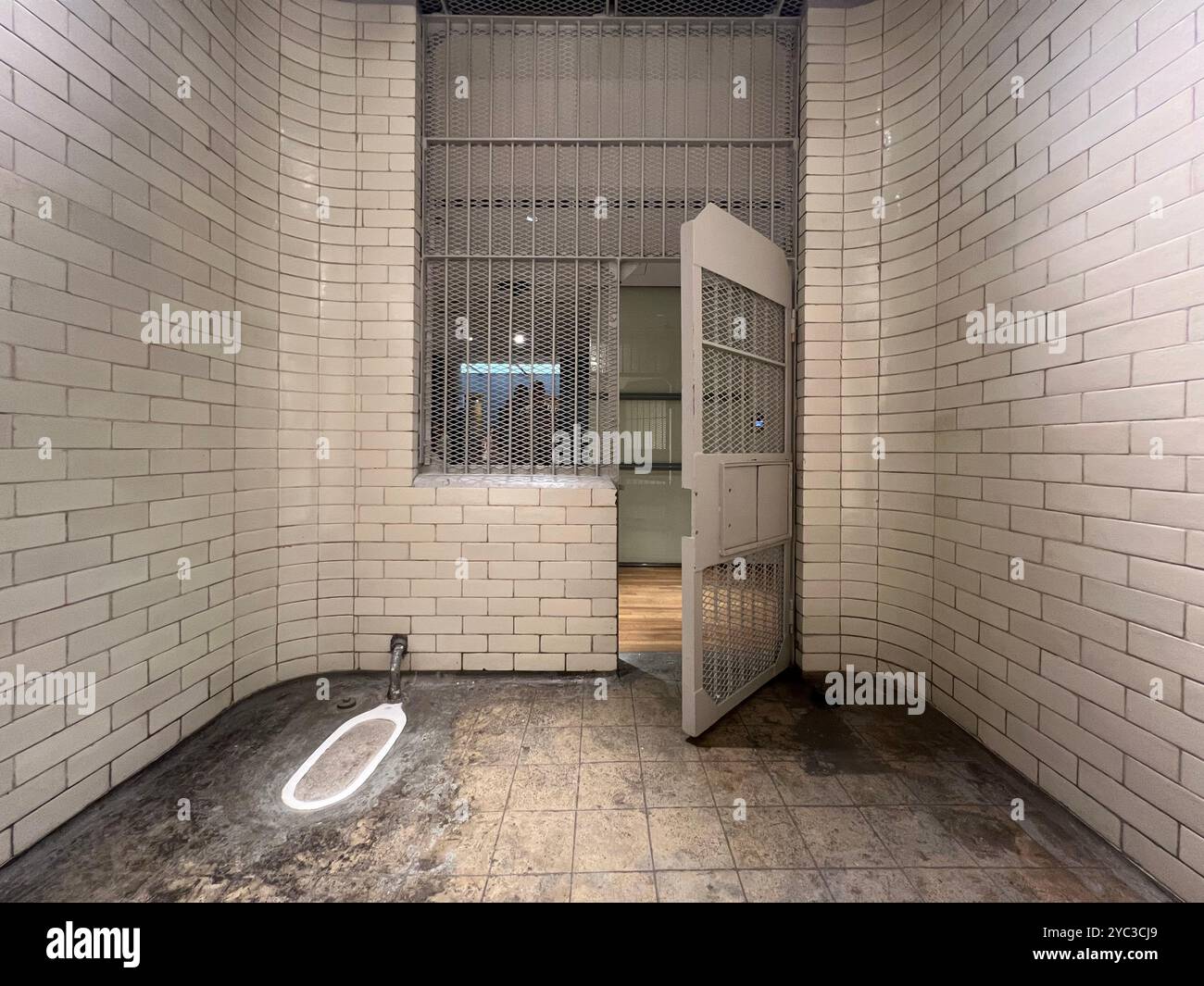 Prison cell interior open for public such as tourists visiting to experience the small room space inside. National Gallery Singapore. - Smartphone Captured Stock Image