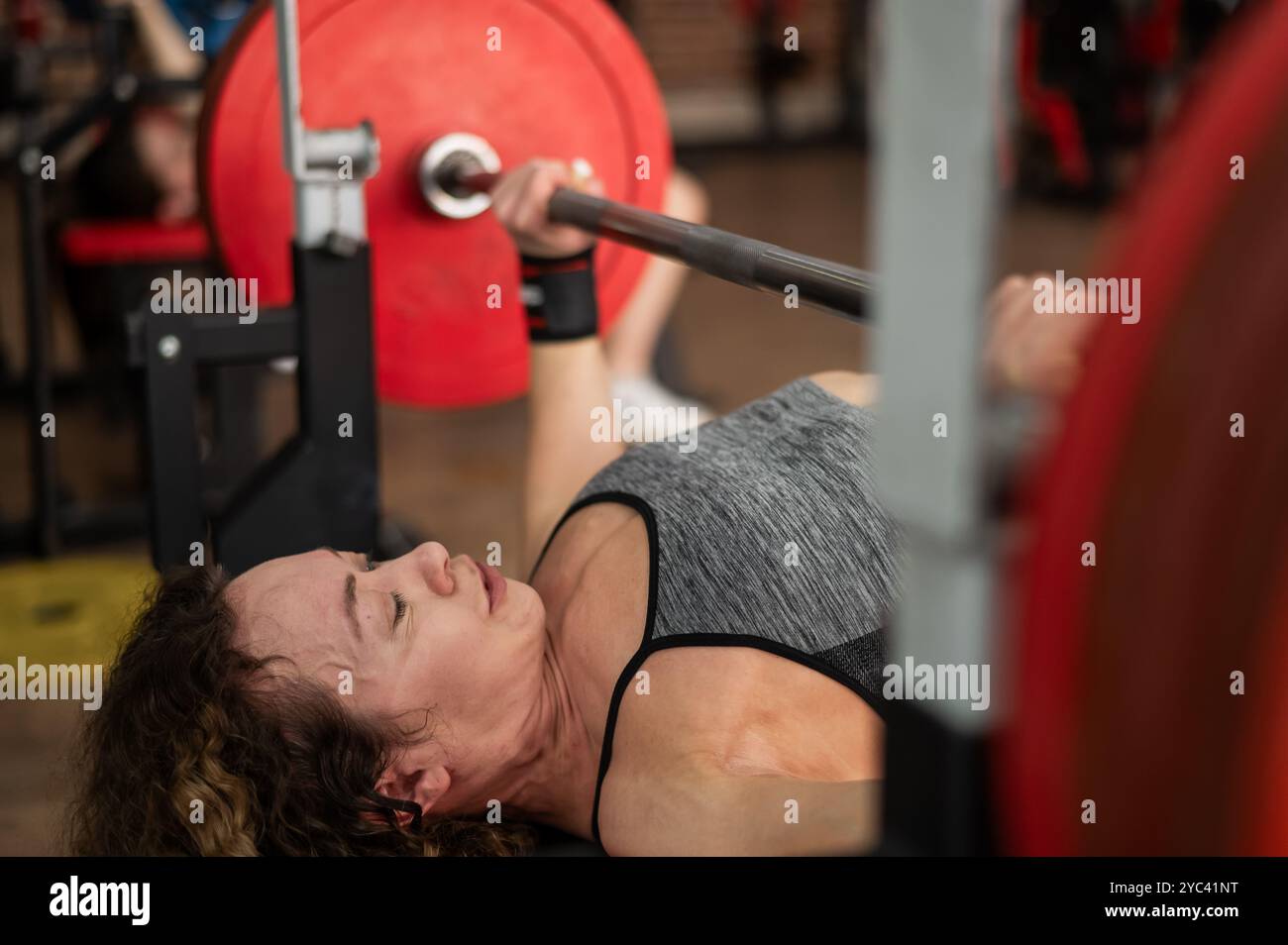 Middle aged woman doing bench press at the gym Stock Photo - Alamy