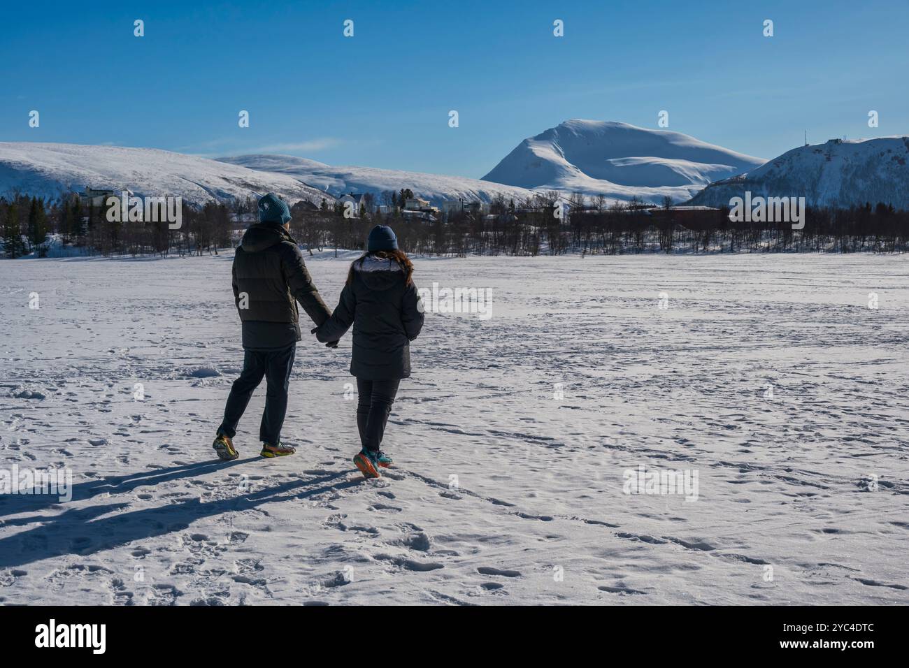 Tromso Norway love couple in snow winter nature landscape at Prestvannet Lake Stock Photo