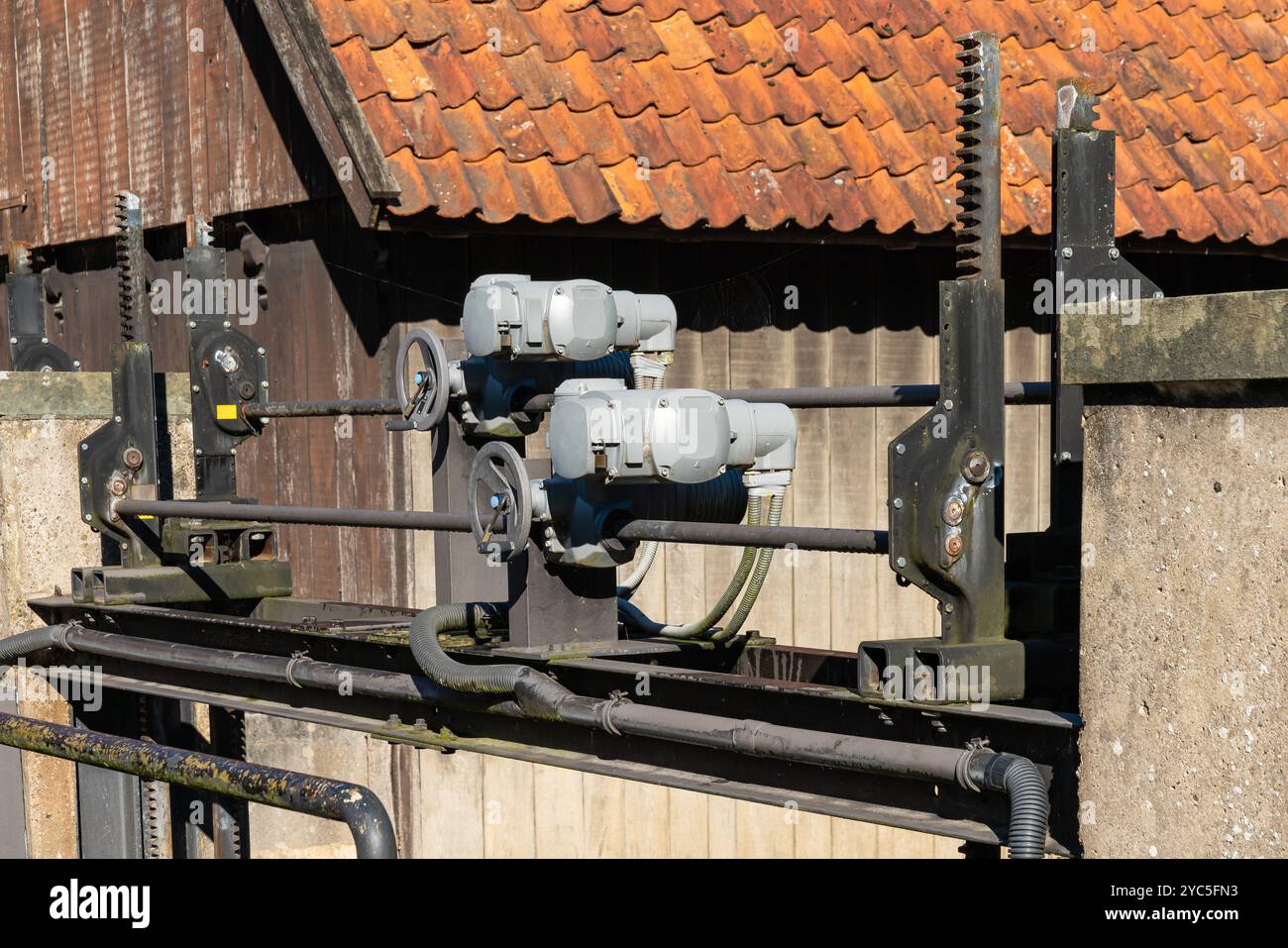 Two electric motors are mounted on a sturdy metal framework atop a ...