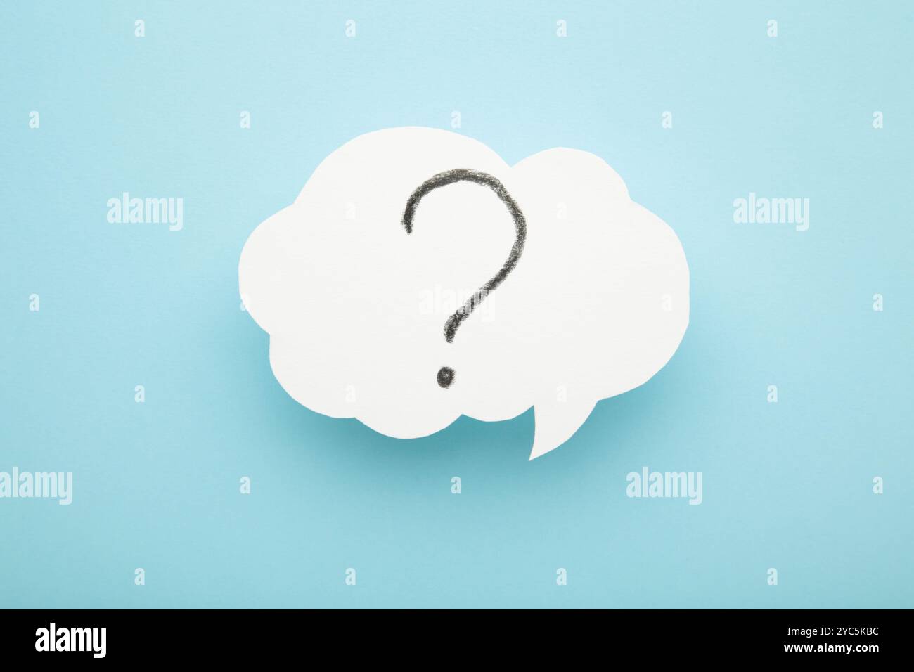 Question mark speech bubble on blue background. Top view Stock Photo