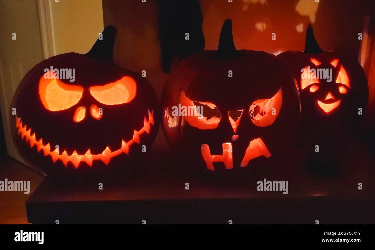 Halloween pumpkins with scary faces in a dark room Stock Photo