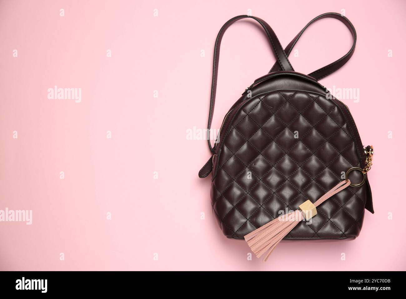 Backpack with leather keychain on pink background, top view. Space for text Stock Photo