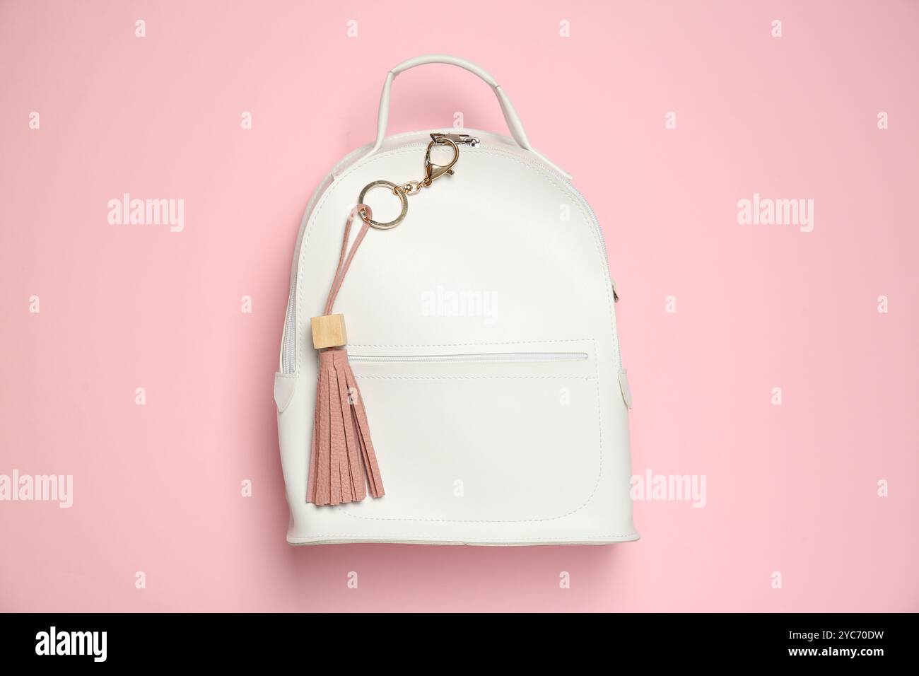 Backpack with leather keychain on pink background, top view Stock Photo