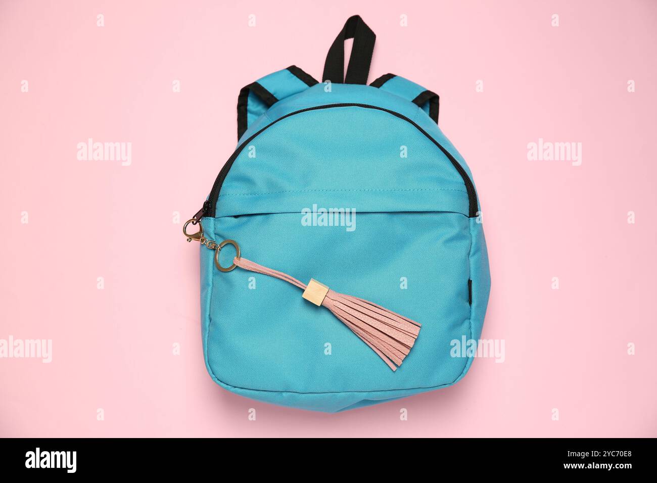 Backpack with leather keychain on pink background, top view Stock Photo