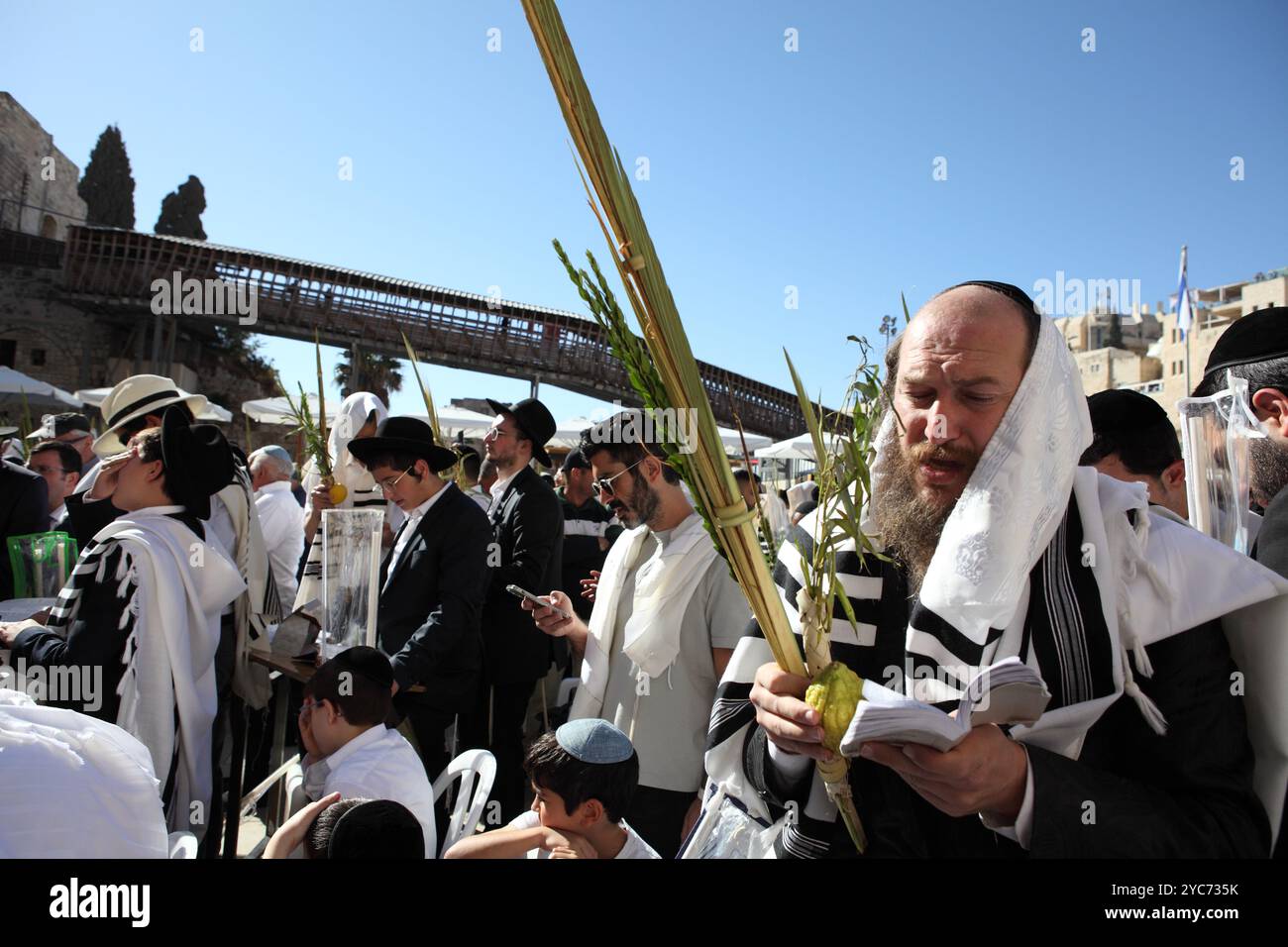 Crowd of Jewish men with prayer shawls or Talith pray at the Western ...