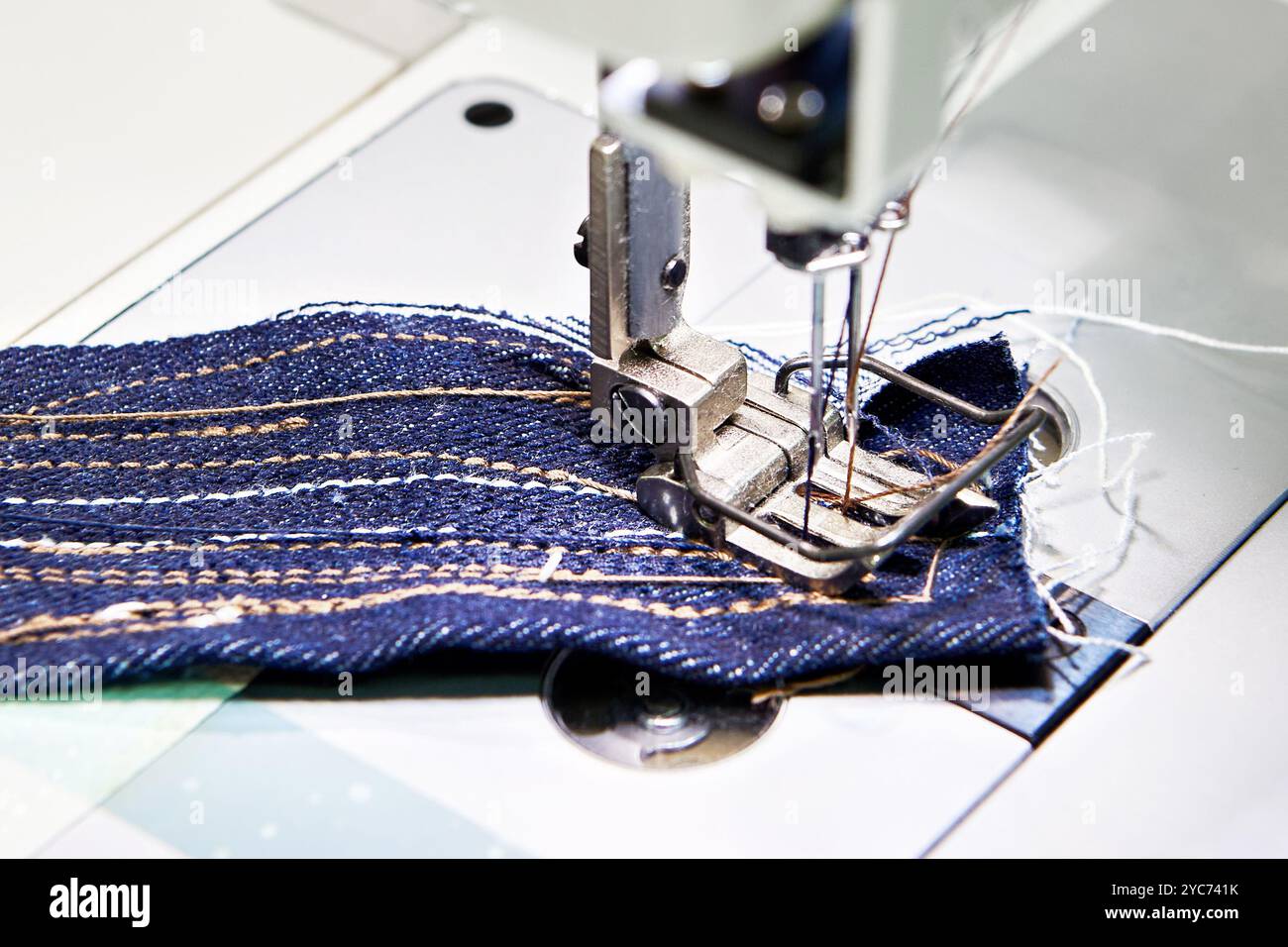 Two-needle sewing machine and piece of fabric Stock Photo