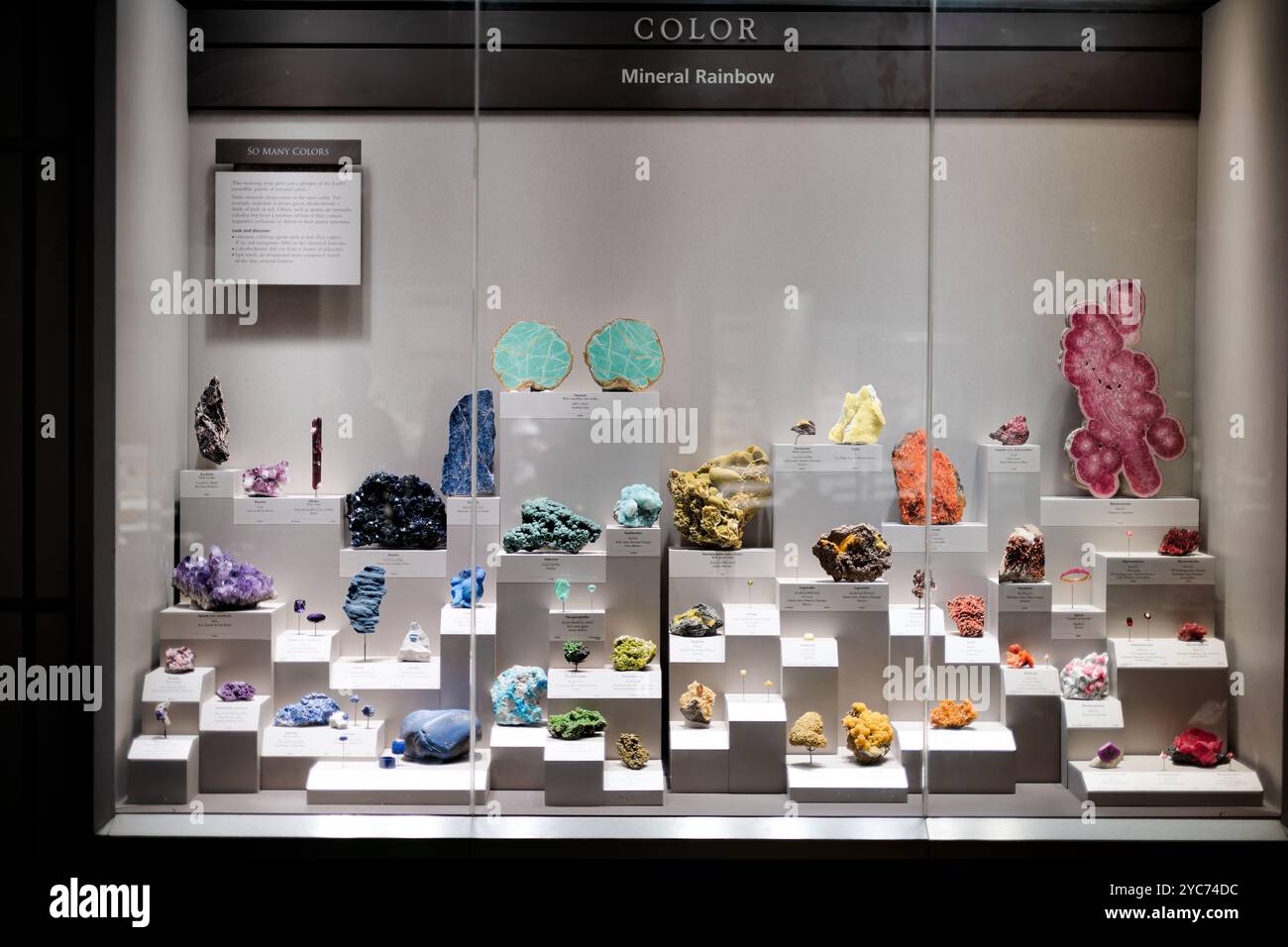 National Museum Of Natural History Mineral Rainbow Washington DC // WASHINGTON DC — The Eberly Minerals and Gems Gallery at the National Museum of Natural History features a striking mineral rainbow display showcasing the spectrum of naturally occurring mineral specimens. This signature exhibit in the museum's renowned mineral collection demonstrates the vast diversity of mineral colors and formations. The carefully curated display arranges specimens by color to create a natural rainbow effect. Stock Photo