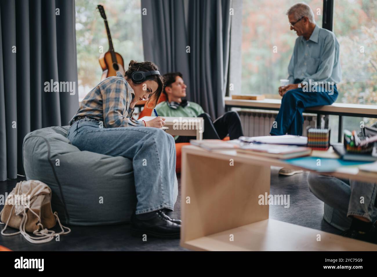 Professor engaging with students in a creative classroom setting Stock Photo
