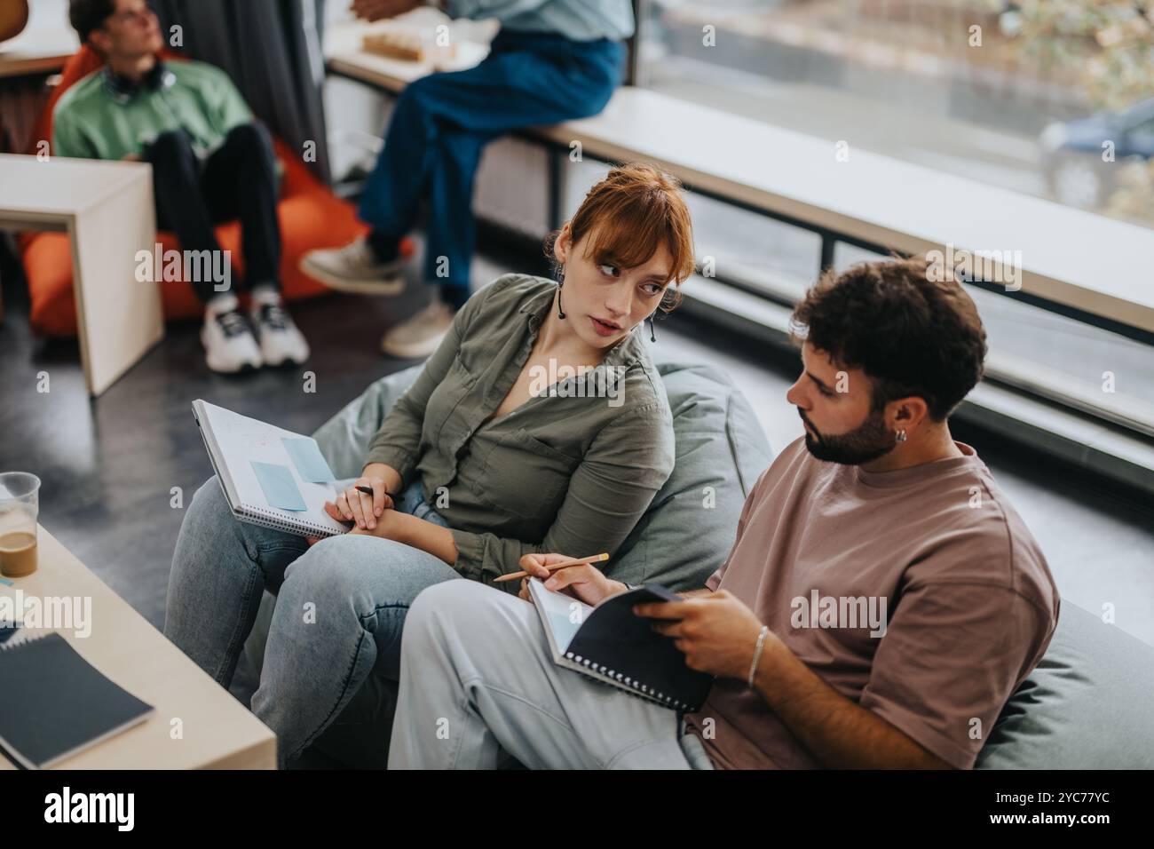 Professor engaging with students in a modern learning environment Stock Photo