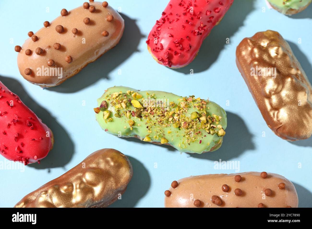 Composition with various glazed eclairs on color background Stock Photo