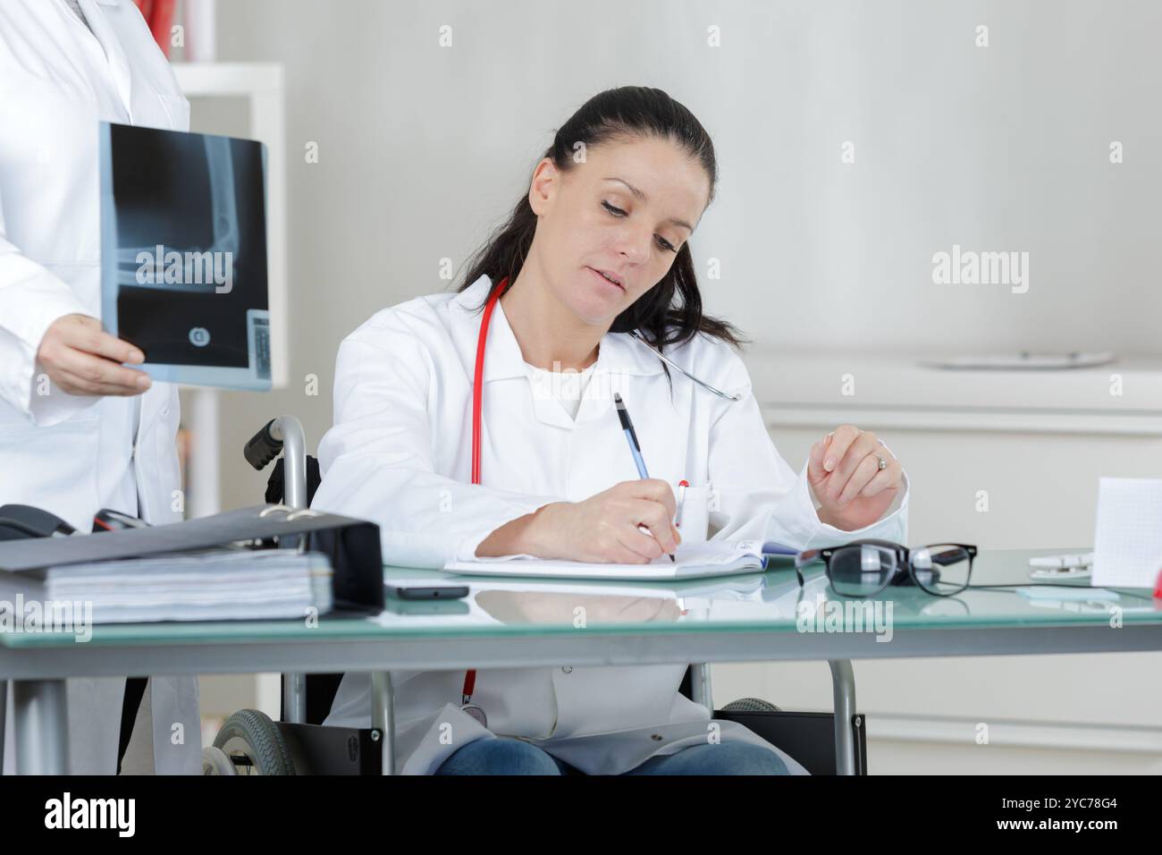 female doctor filling out application form Stock Photo - Alamy
