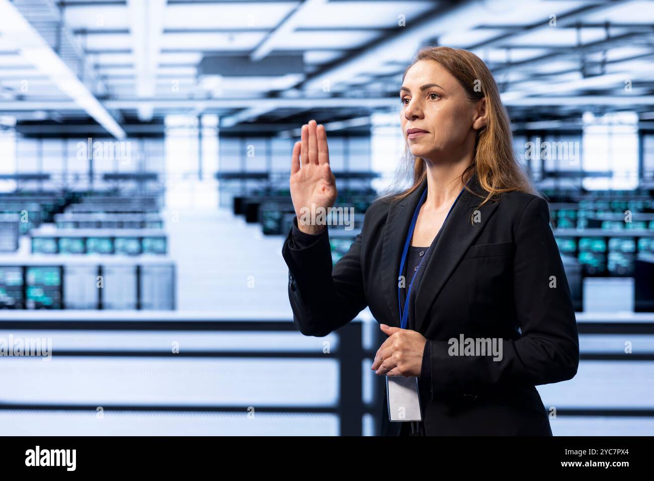 Engineer in server hub using AR technology checking hardware after installing storage units. Data center worker using augmented reality to do maintenance after replacing mainframes components Stock Photo