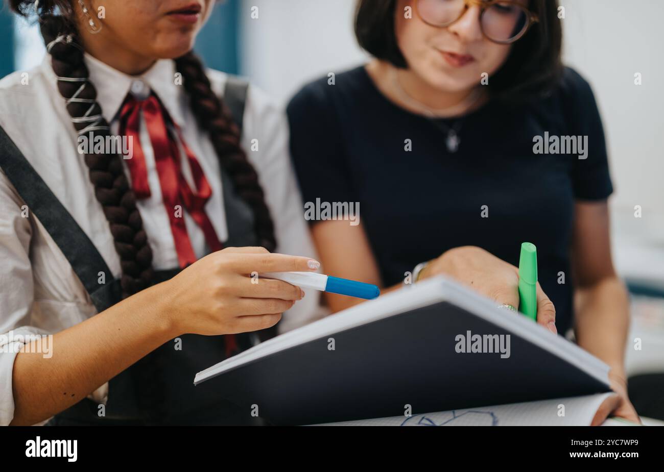 Two students collaborating during a study session at school Stock Photo