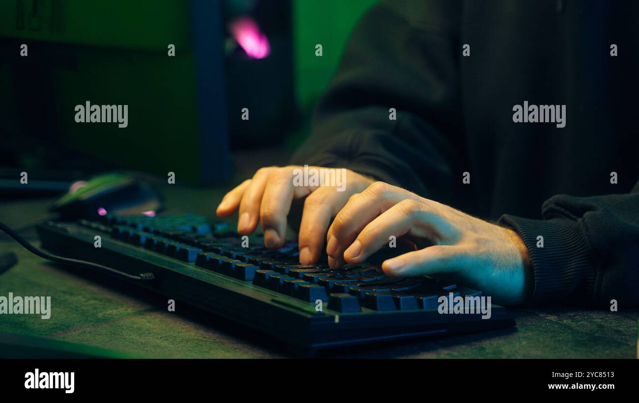 Programmer man keyboard computer typing hacker internet networking online professional software cyber tech security pc web coding browsing gaming Stock Photo