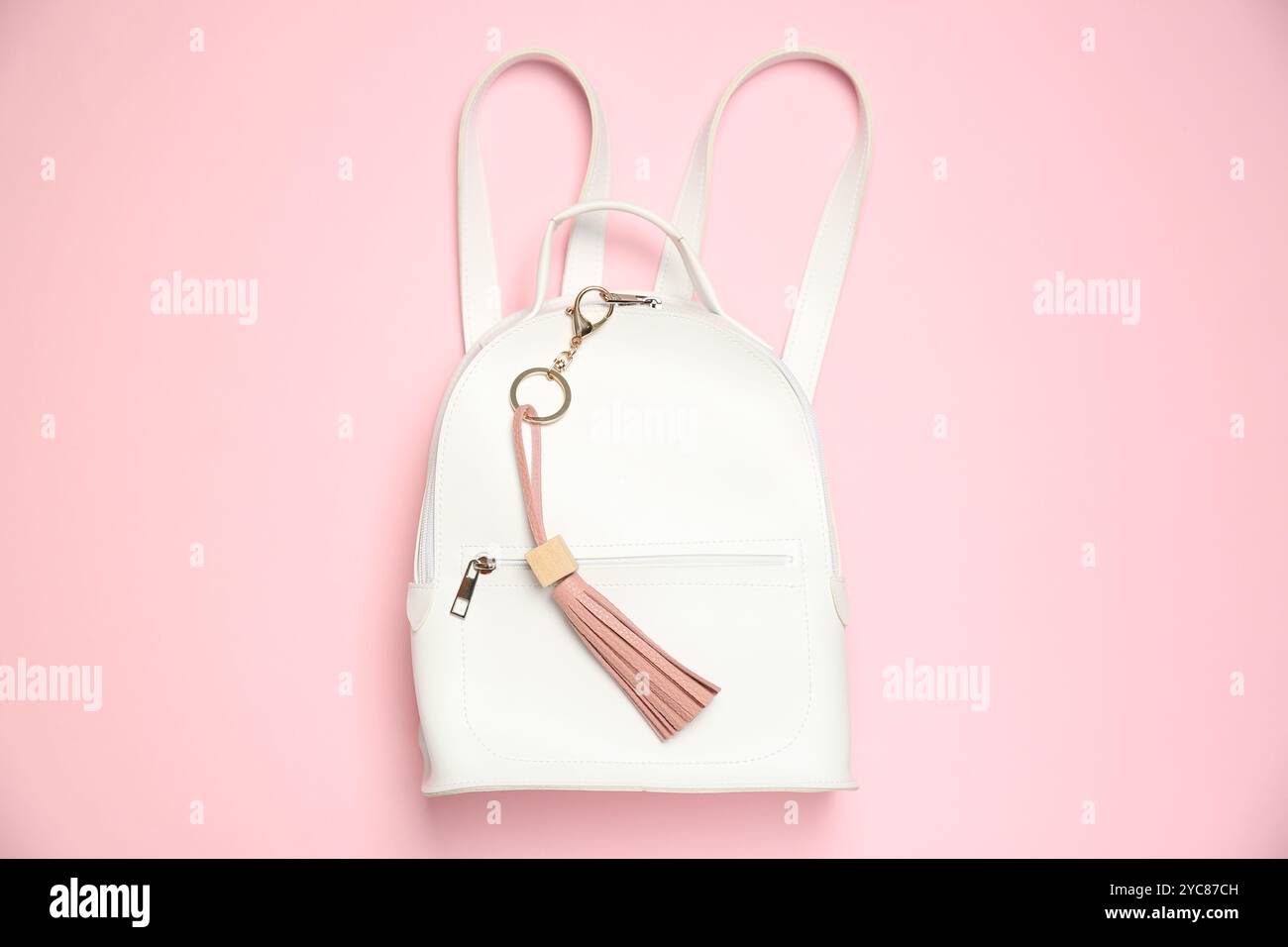 Backpack with leather keychain on pink background, top view Stock Photo