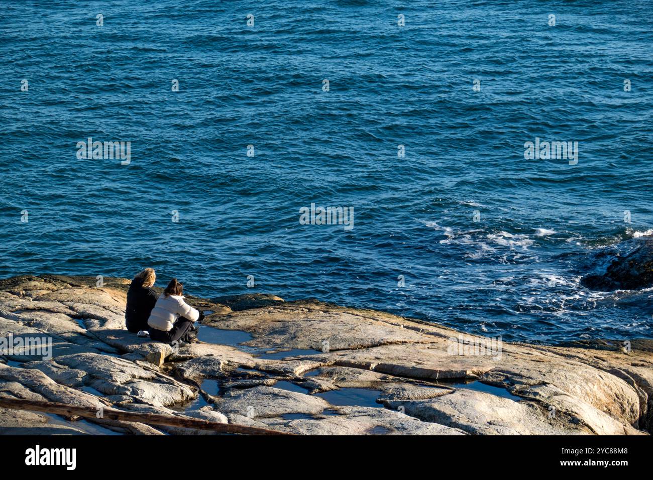 Women sit on rocks hi-res stock photography and images - Alamy