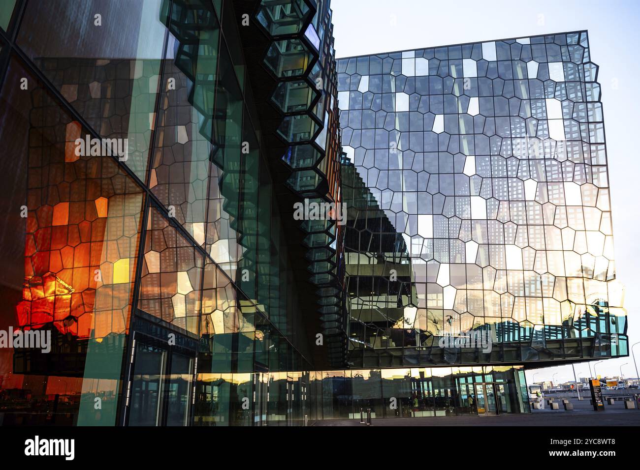 A modern building with a reflective glass facade, reflecting the setting sun, Harpa Concert Hall, Reykjavik, Iceland, Europe Stock Photo