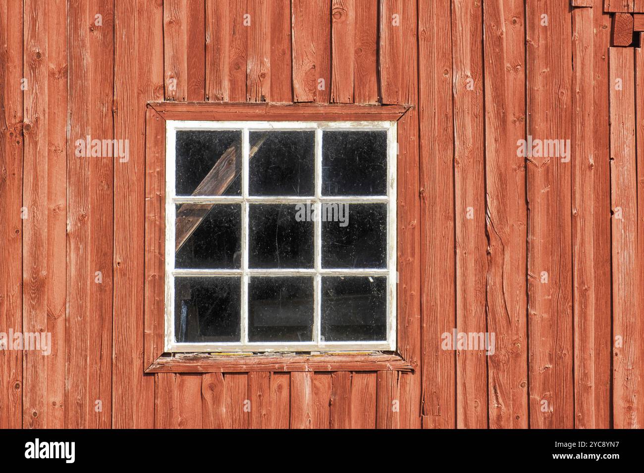 Window on a red weathered barn Stock Photo