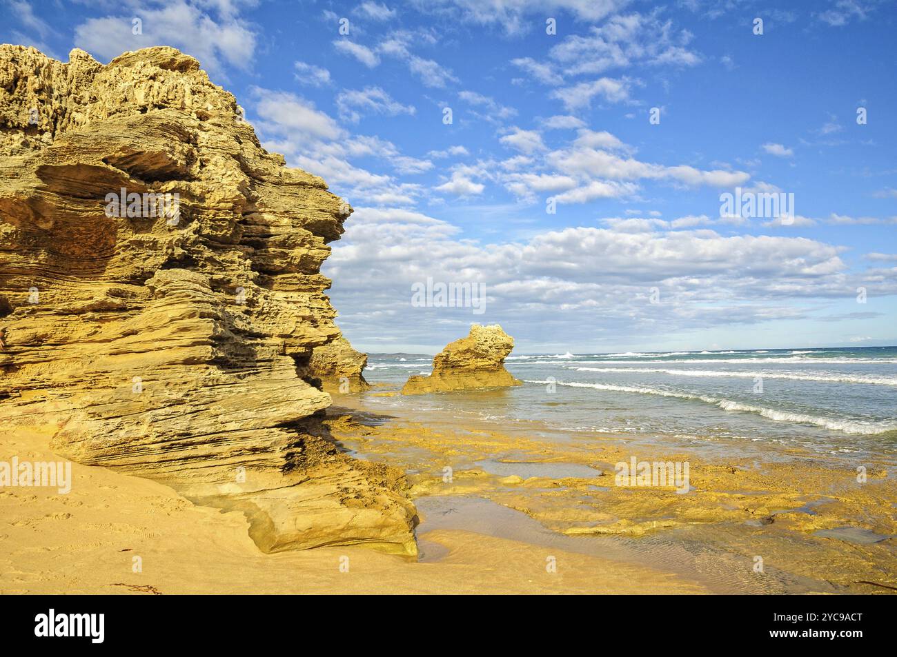 Sculptured rocks under blue sky and light clouds at Point Lonsdale ...