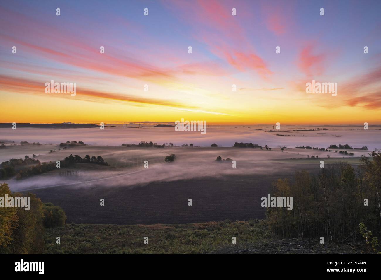 Sunrise with fog in the landscape Stock Photo - Alamy