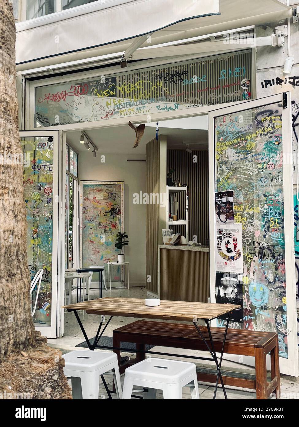 Specialty coffee shop in the center of Athens, Greece with graffiti and artwork. - Smartphone Captured Stock Image