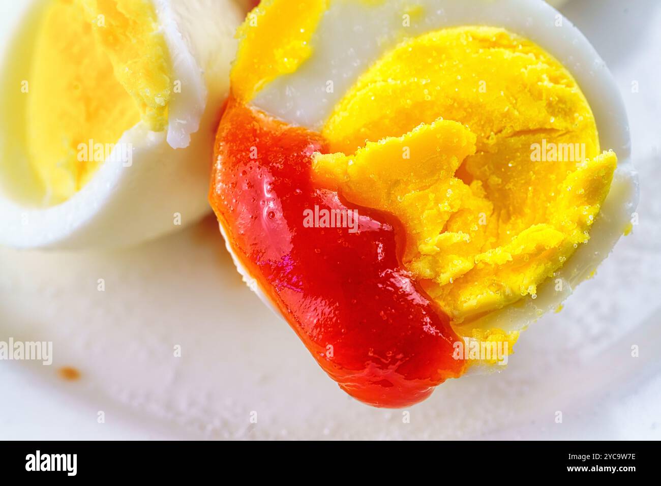 Boiled egg with ketchup and salt. Stock Photo