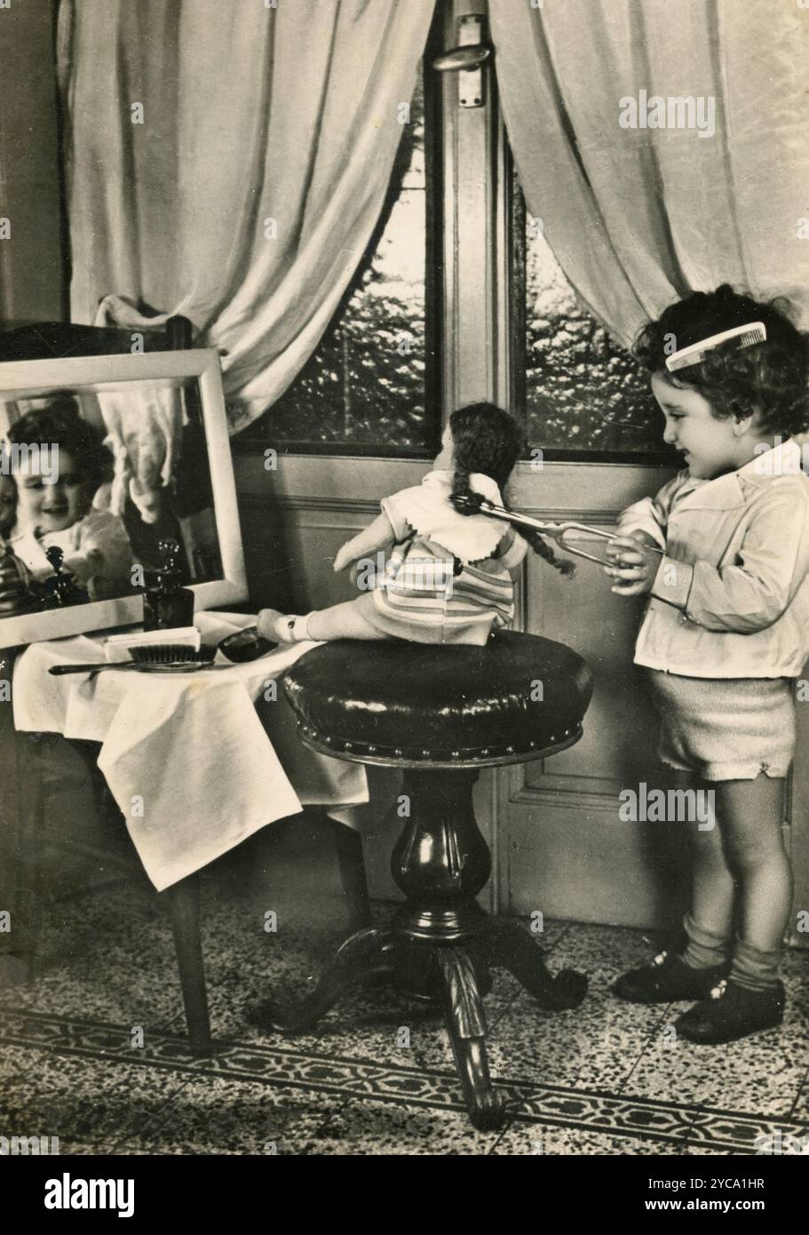 Child playing with a doll, Italy 1950s Stock Photo - Alamy
