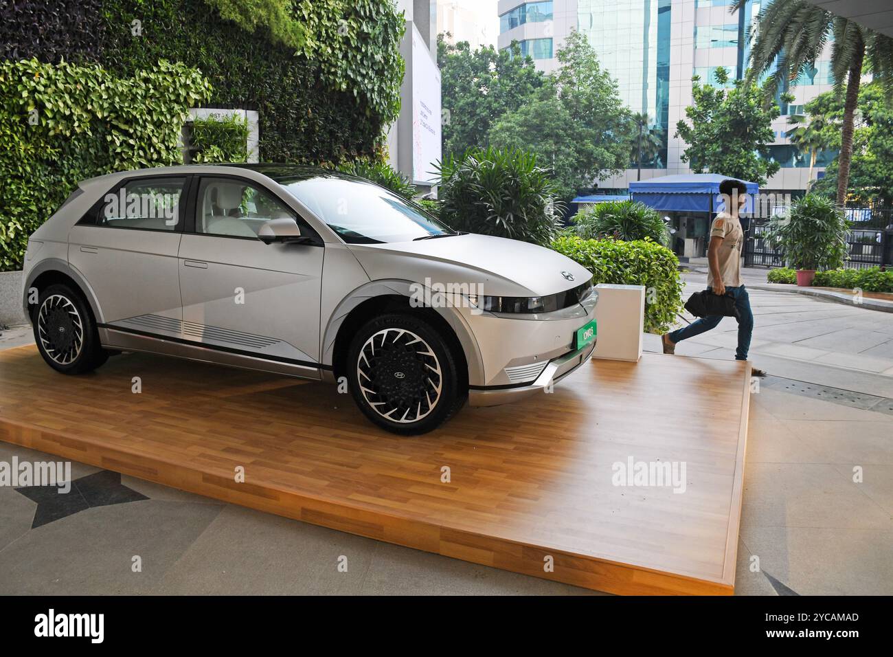 Mumbai, India. 22nd Oct, 2024. A man walks past Hyundai Ioniq 5 ...