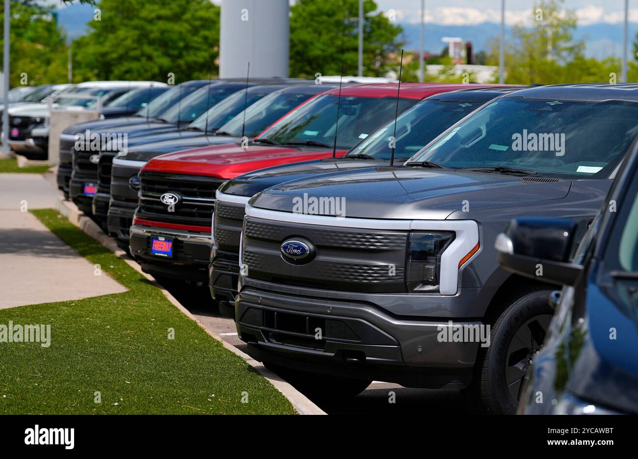 FILE 2024 F150 and Lightning electric pickup trucks sit at a Ford