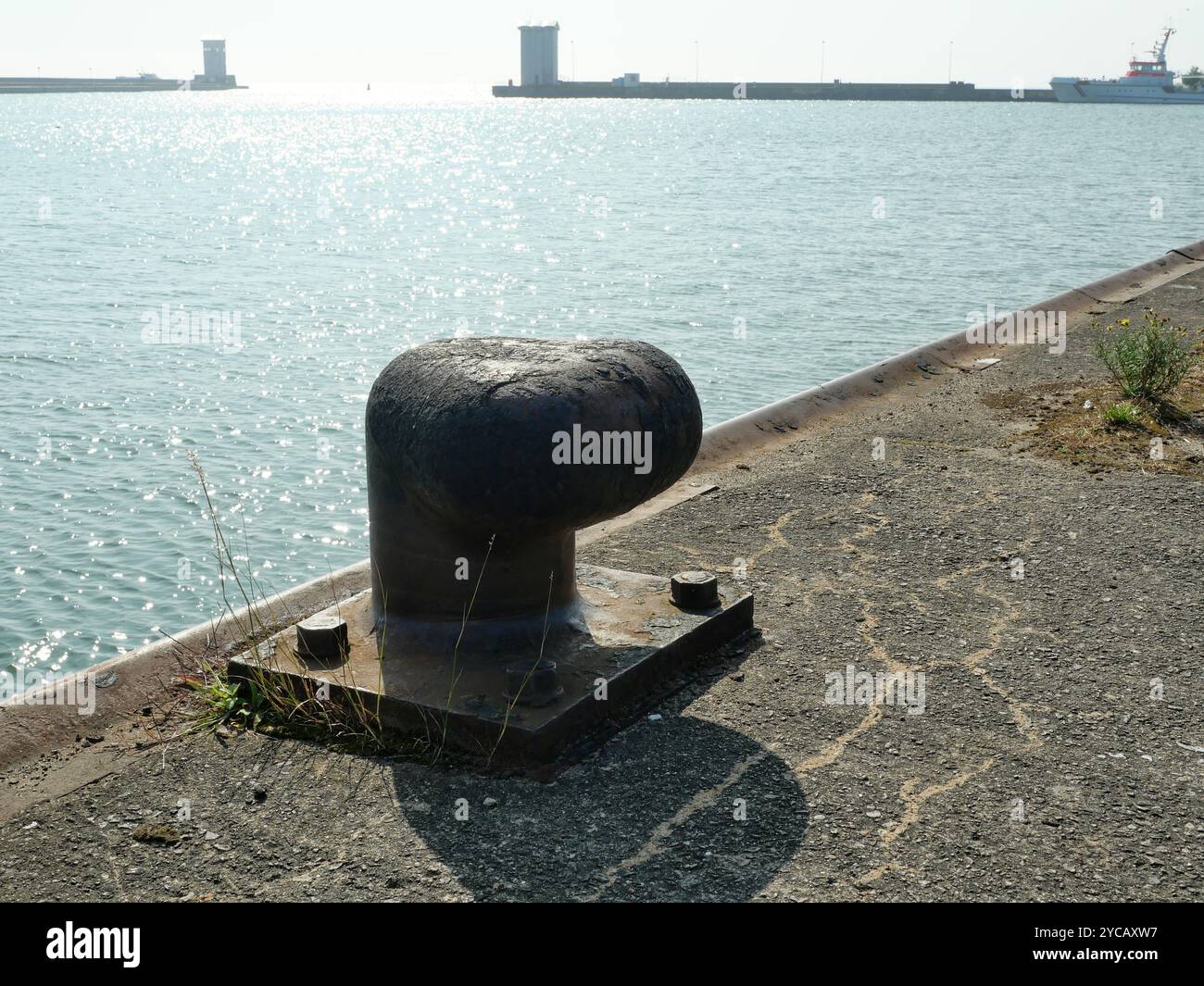 The rusty cast iron bollards are impressive witnesses to maritime history. Stock Photo