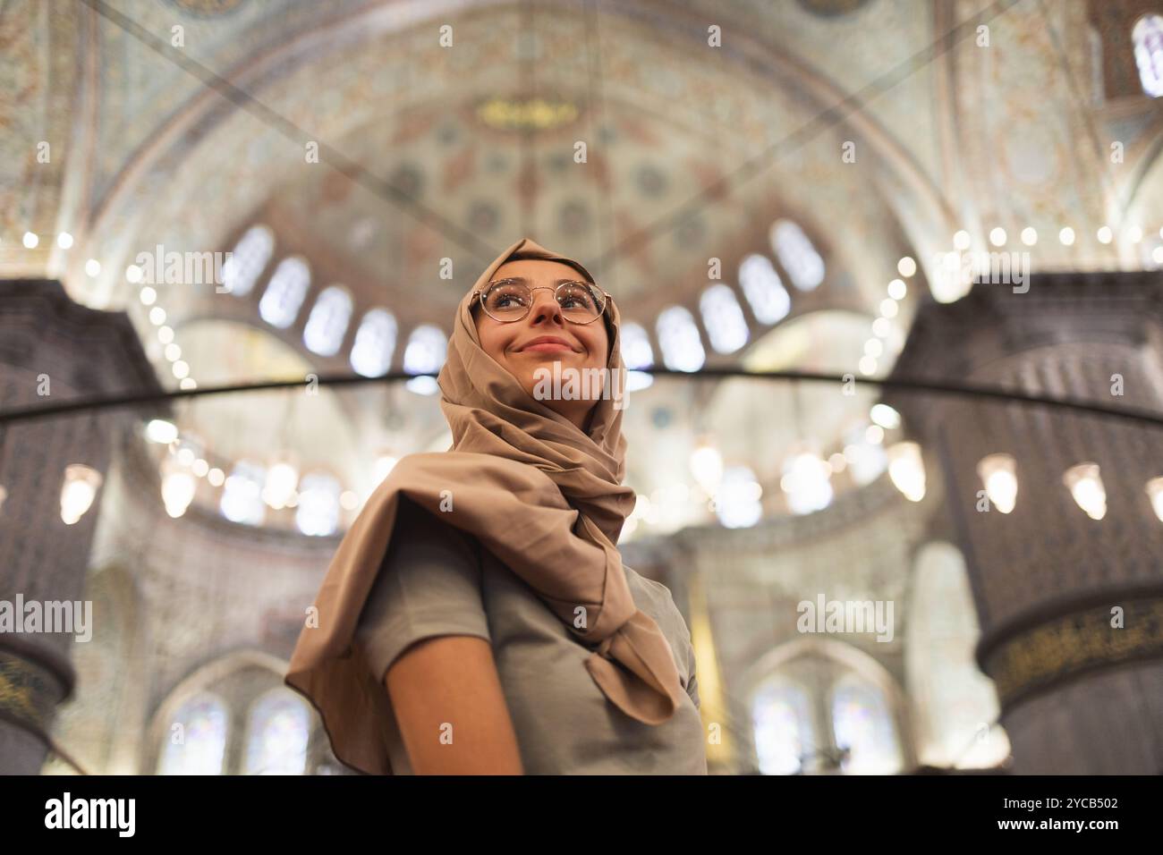From Below A Young Woman Dressed In A Traditional Hijab Is Seen from-below-a-young-woman-dressed-in-a-traditional-hijab-is-seen