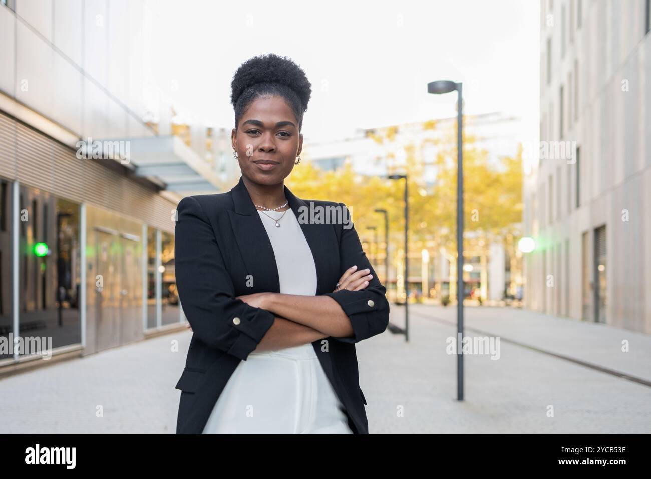 Confident African American woman in a smart black blazer and white ...