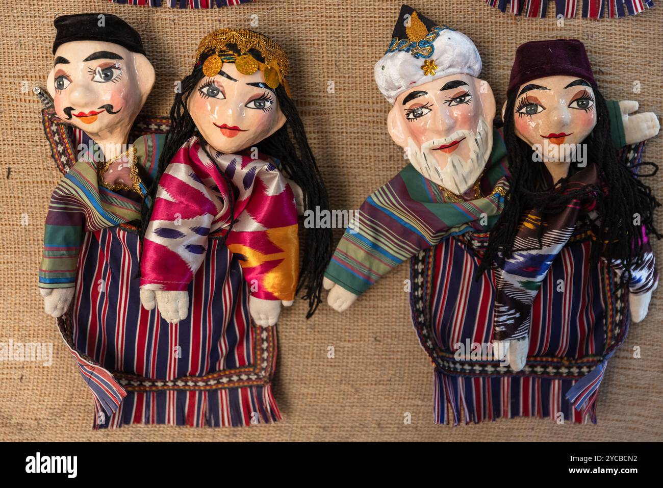 Handmade Uzbek hand puppets for sale are on the wall of tourist shop in old town of Bukhara, Uzbekistan Stock Photo