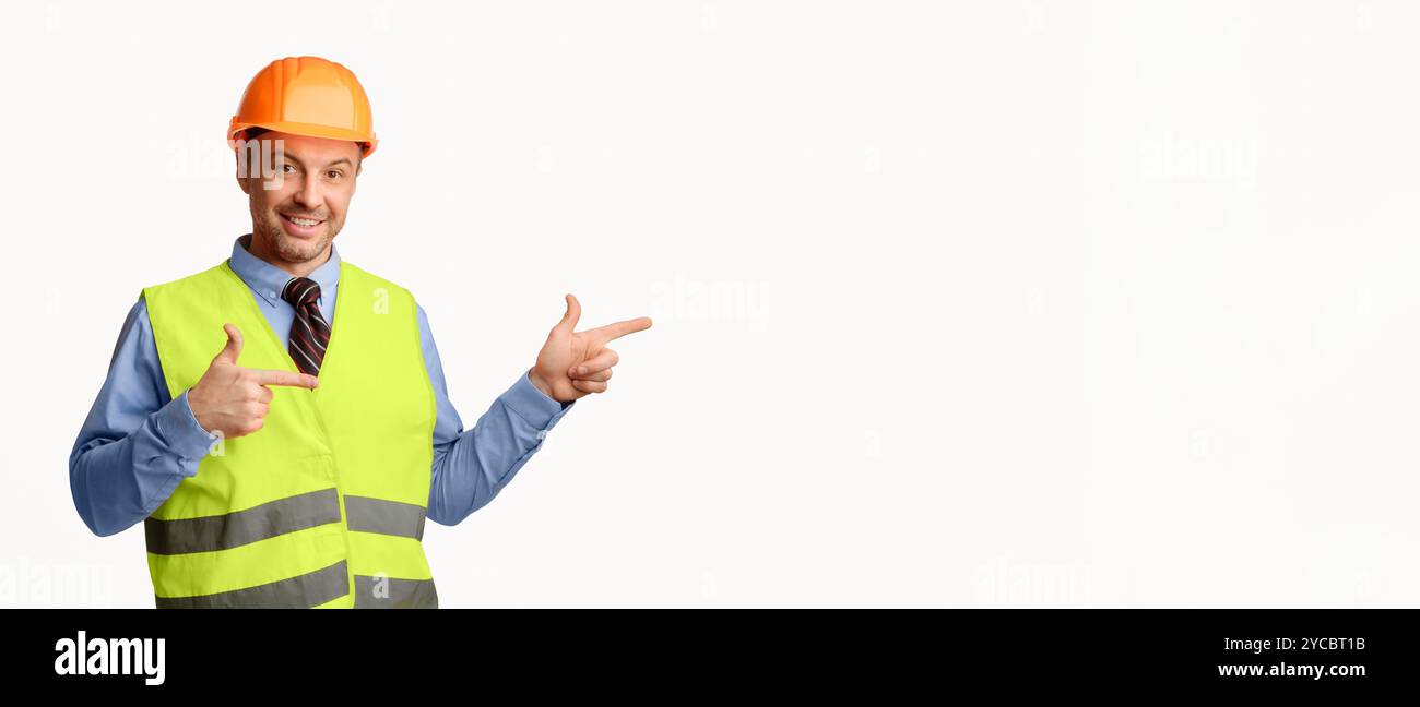 Construction Worker Pointing Fingers Aside Posing On White Background, Panorama Stock Photo