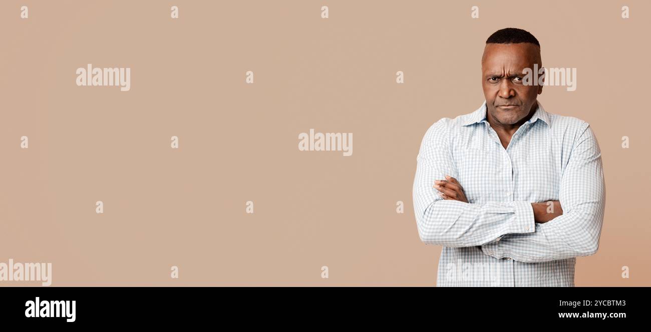 Grumpy mature african american man looking at camera Stock Photo