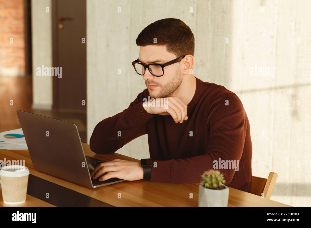Office Manager Man Working On Laptop Computer Sitting At Workplace Stock Photo