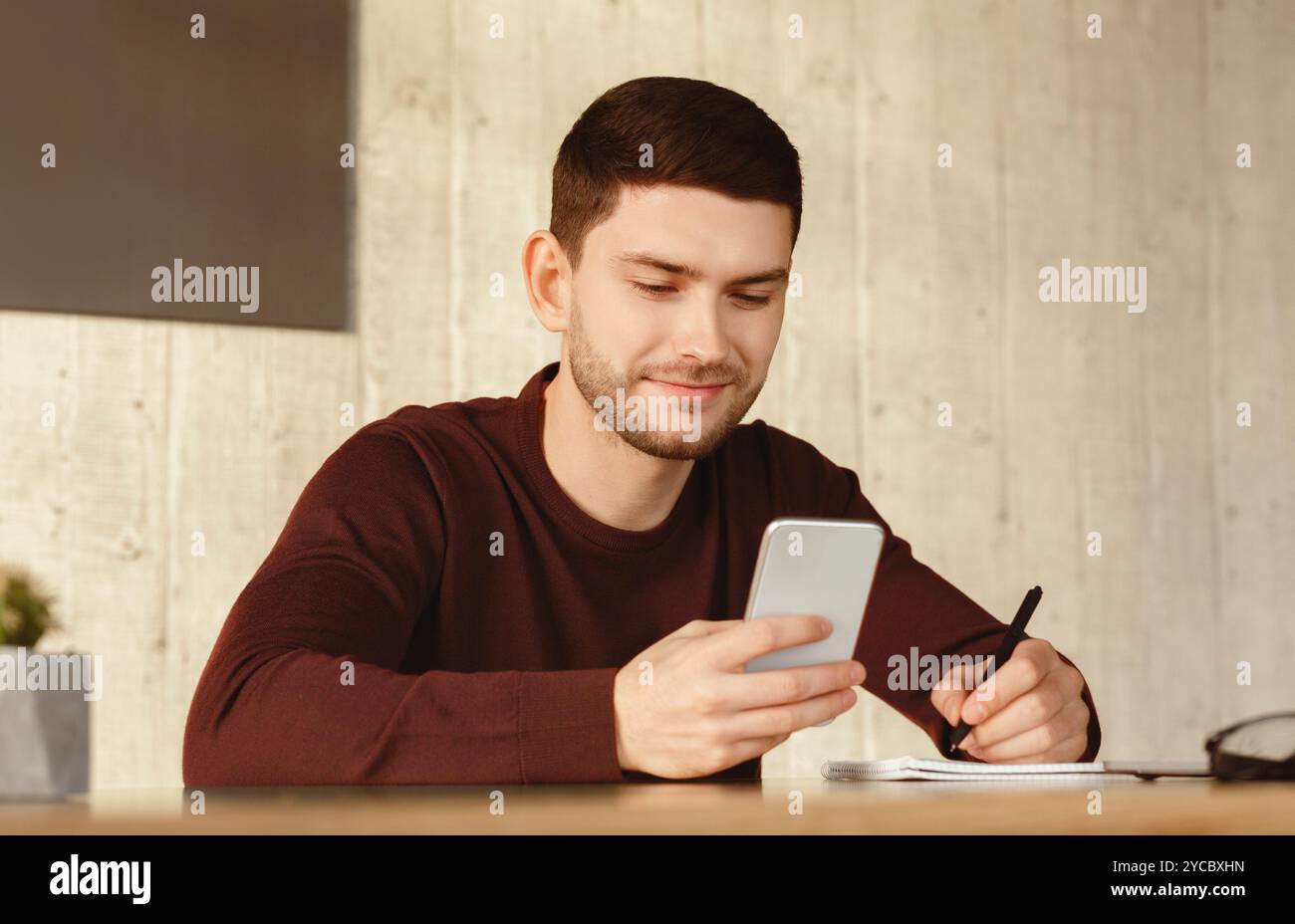 Student Guy Using Smartphone Learning Sitting At Home Stock Photo