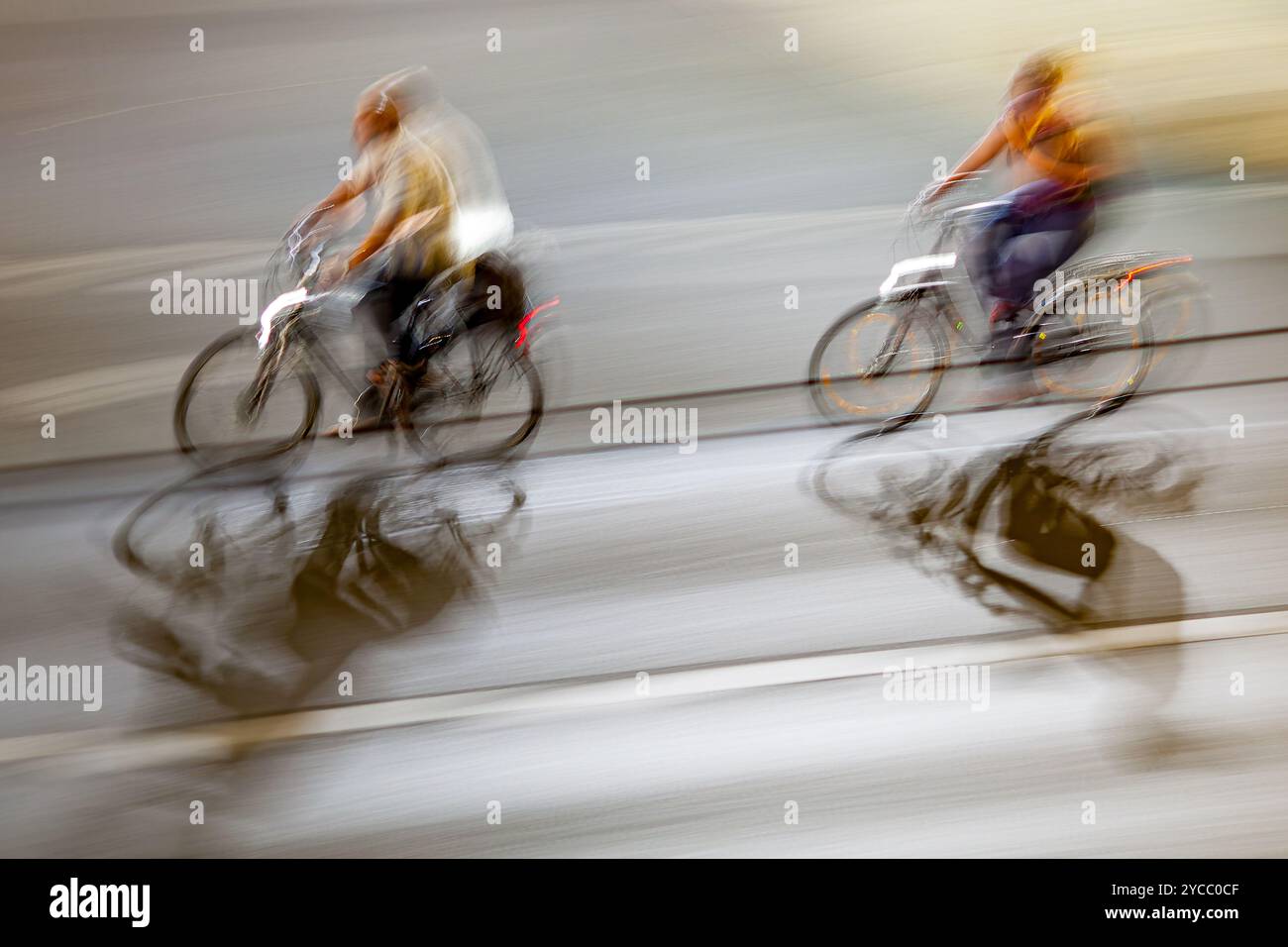Motion blur image of cyclists riding through the city at night ...