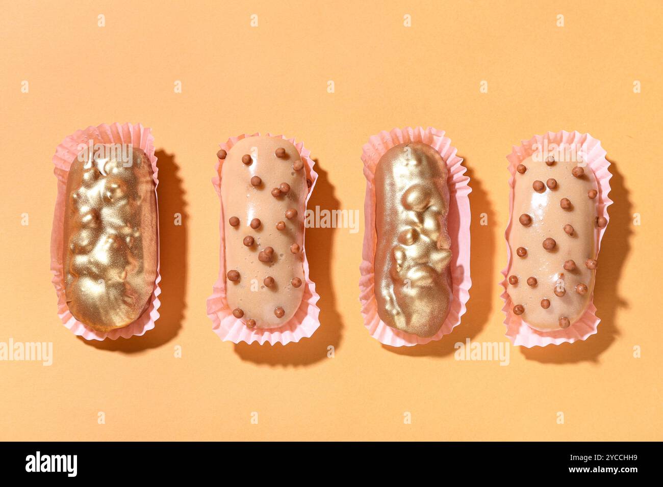 Composition with different glazed eclairs on color background Stock Photo