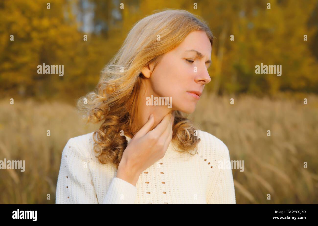 Sick exhausted young woman suffering from acute sore in throat flu ...