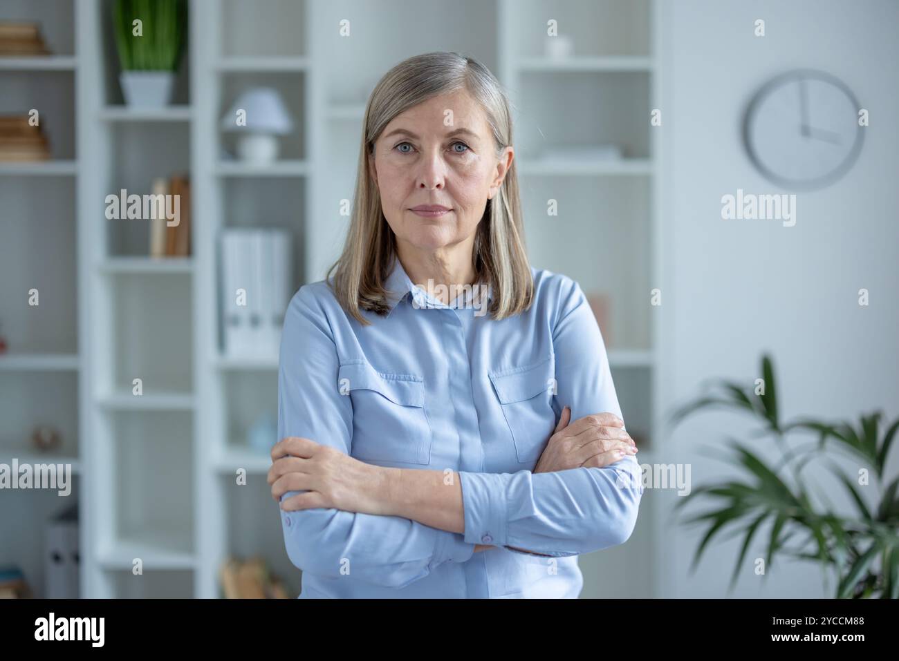 Senior woman in blue shirt hi-res stock photography and images - Alamy