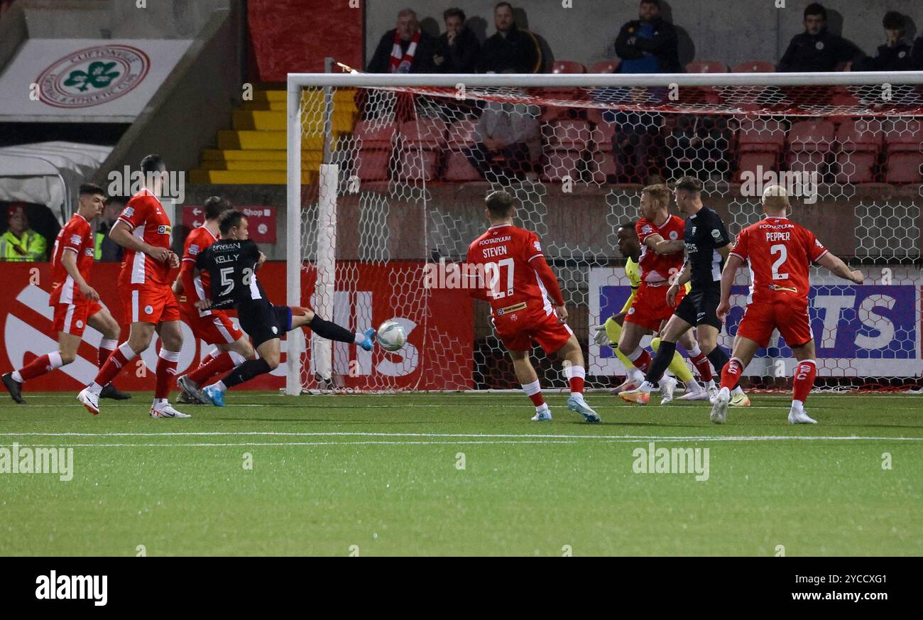 Solitude, Belfast, Northern Ireland, UK. 22 Oct 2024. Sports Direct Premiership – Cliftonville v Coleraine v  . Irish Premiership action from tonight's game in Belfast. (Cliftonville in red. Early chance for Graham Kelly (Coleraine). Credit: CAZIMB/Alamy Live News. Stock Photo