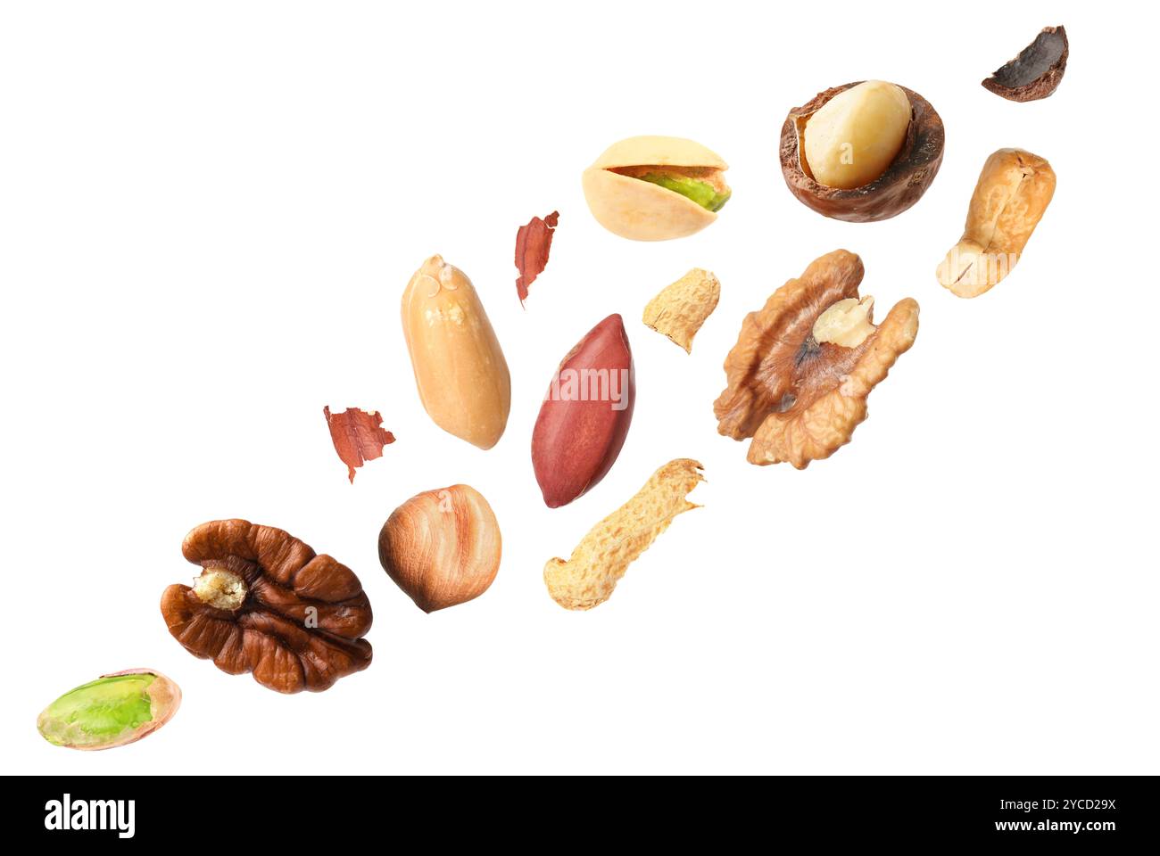 Macadamia and other nuts in air on white background Stock Photo