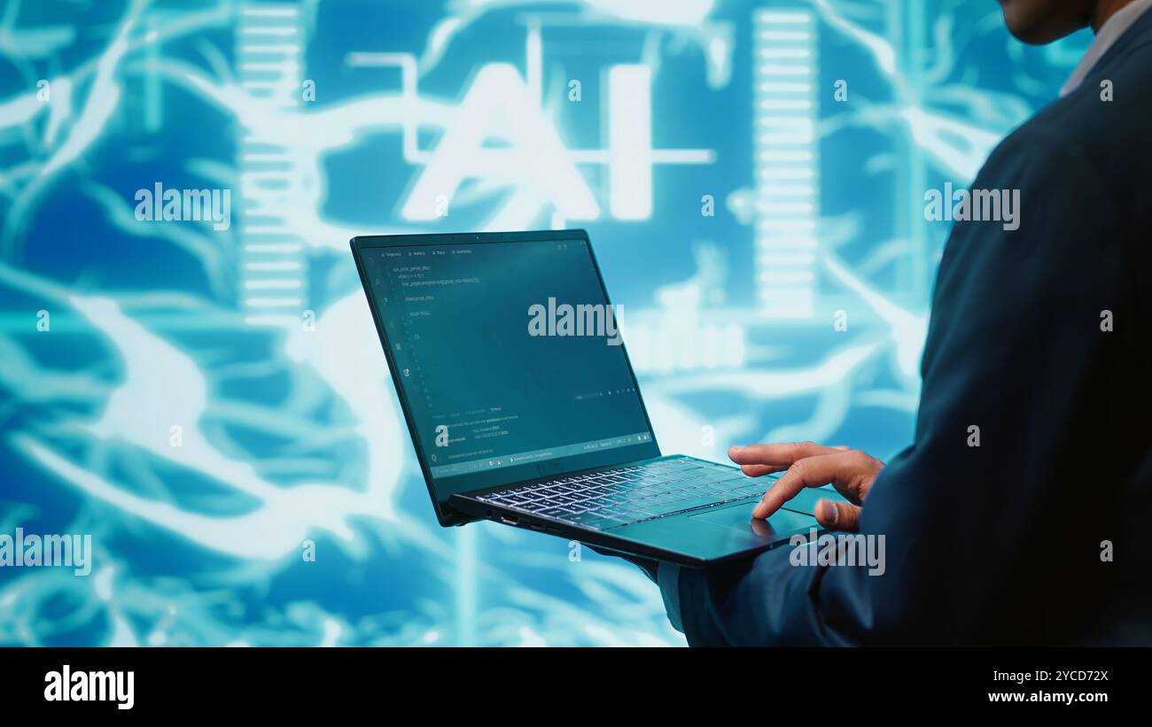 System administrator solving tasks on laptop, running artificial intelligence programming scripts. Close up shot of technician manipulating lines of code for AI applications development, camera A Stock Photo