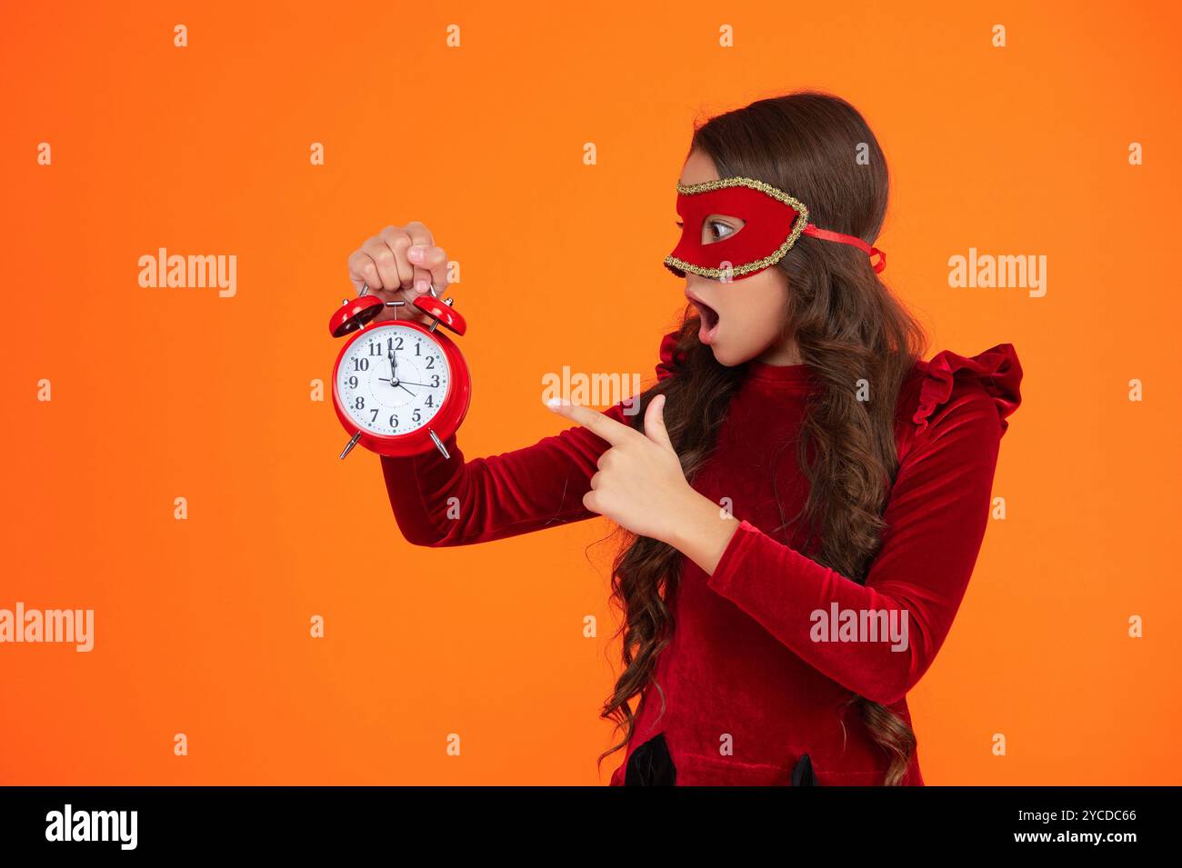 Party countdown. Teen girl in party mask costume with clock. Girl late ...